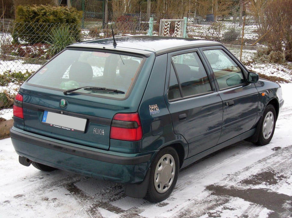 Rear view of a 1990s compact hatchback with distinctive tail lights and rear windshield wiper
