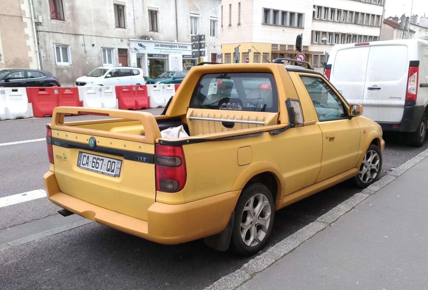 Compact yellow pickup with rear spoiler and silver alloy wheels