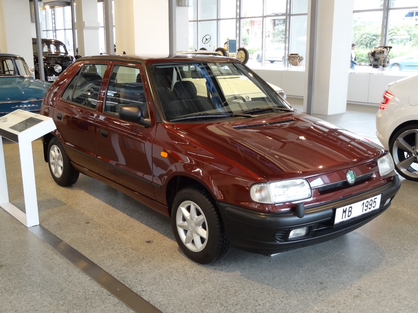 Front-side view of a 1990s hatchback with rounded headlights