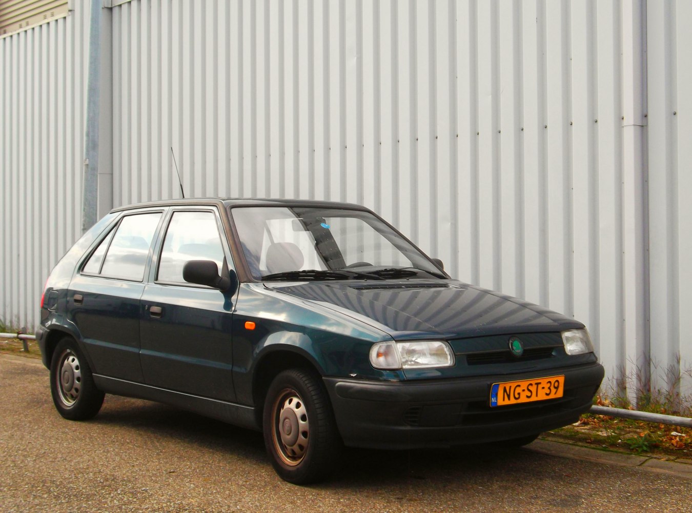 Compact five-door hatchback with steel wheels and simple design