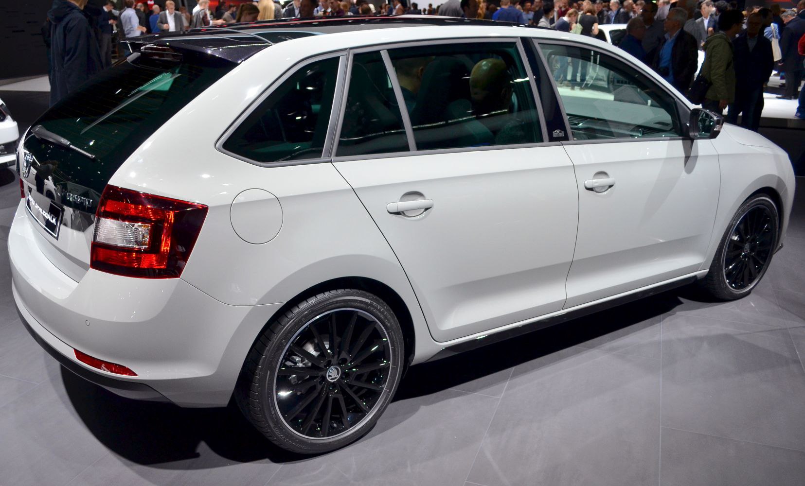 White hatchback rear side with black multi-spoke alloy wheels