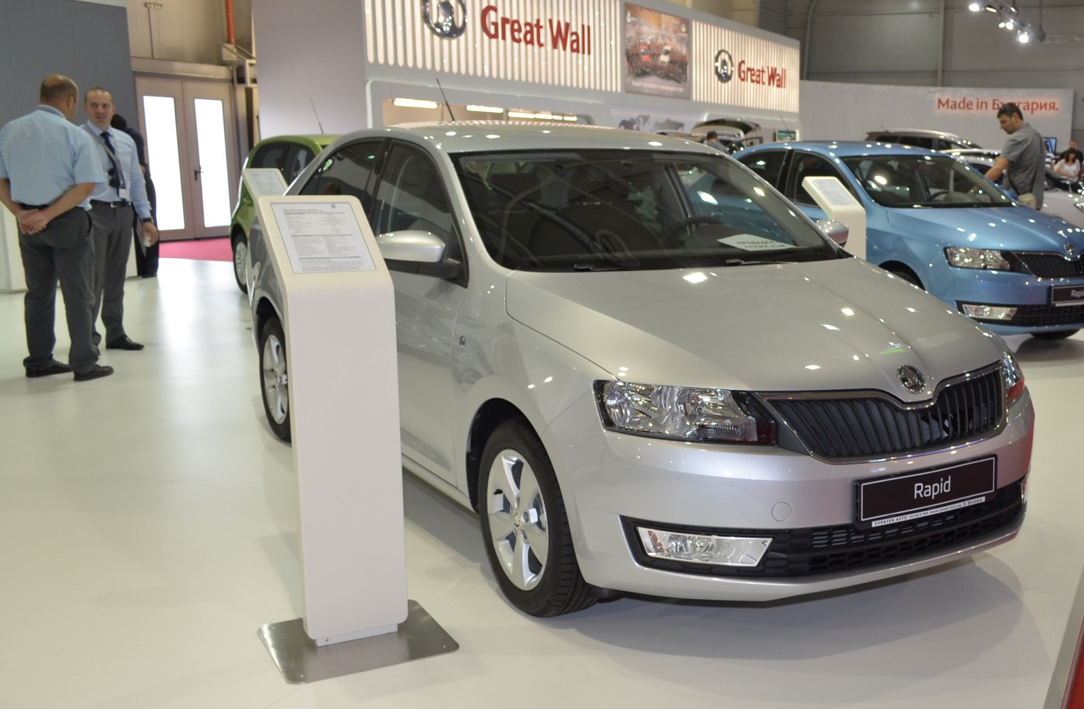 Compact sedan front view with sharp headlights and alloy wheels