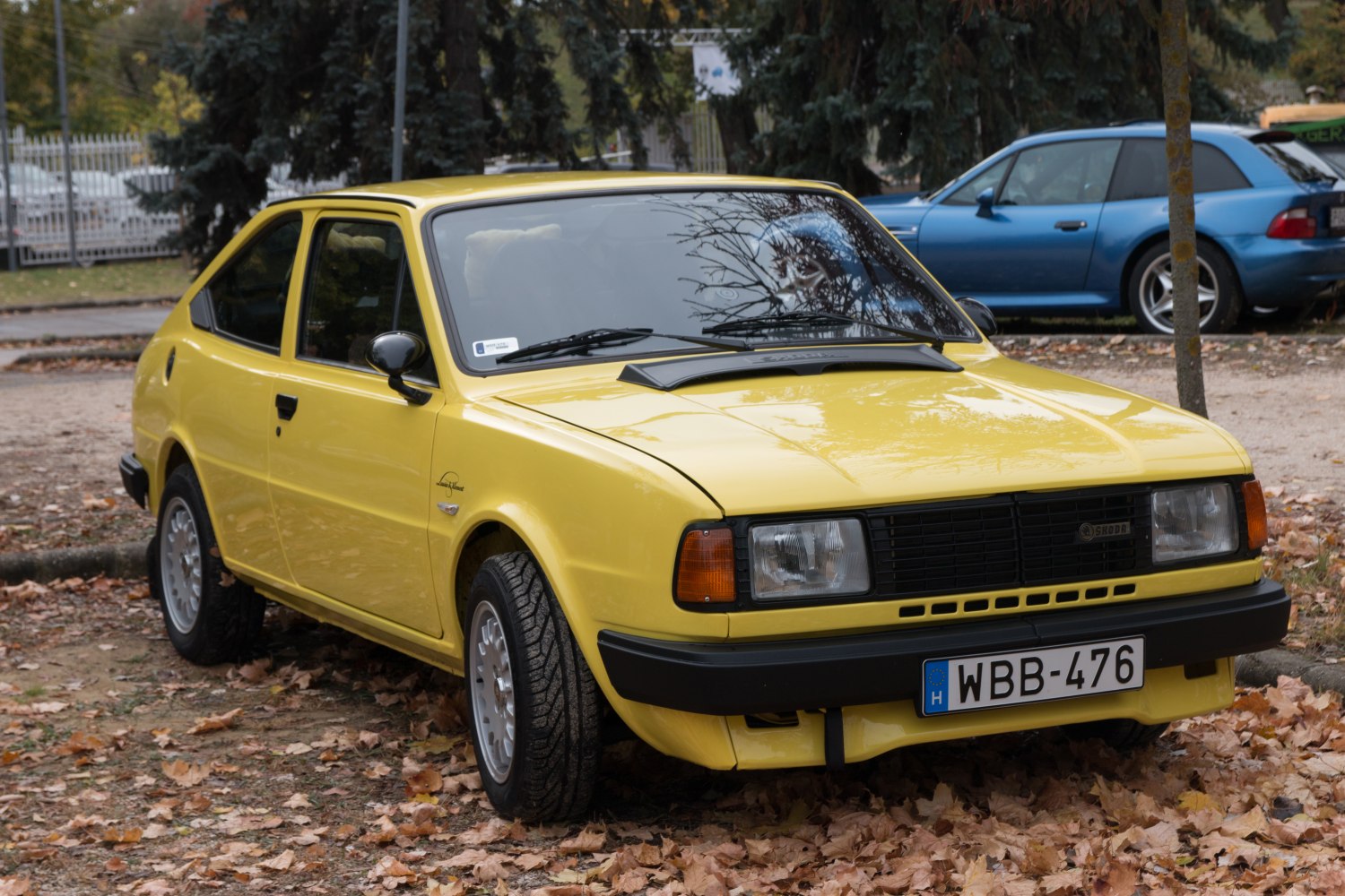 Yellow vintage hatchback with rectangular headlights and alloy wheels