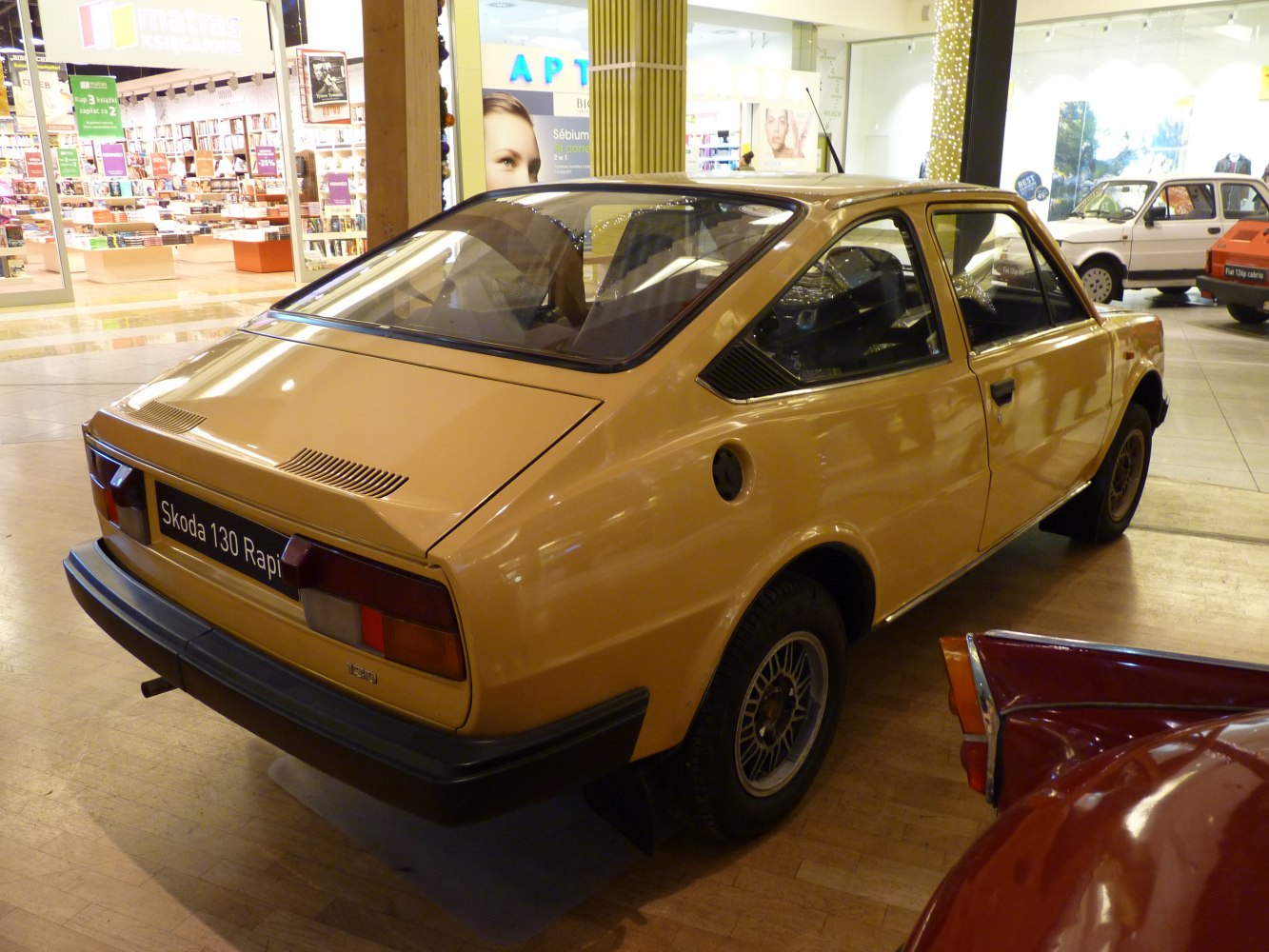 Rear view of vintage hatchback with angular taillights and rear window vents.