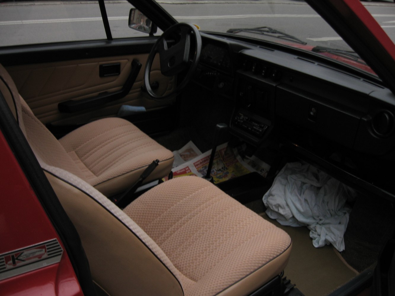 Beige fabric seats and manual gear shift in retro car interior