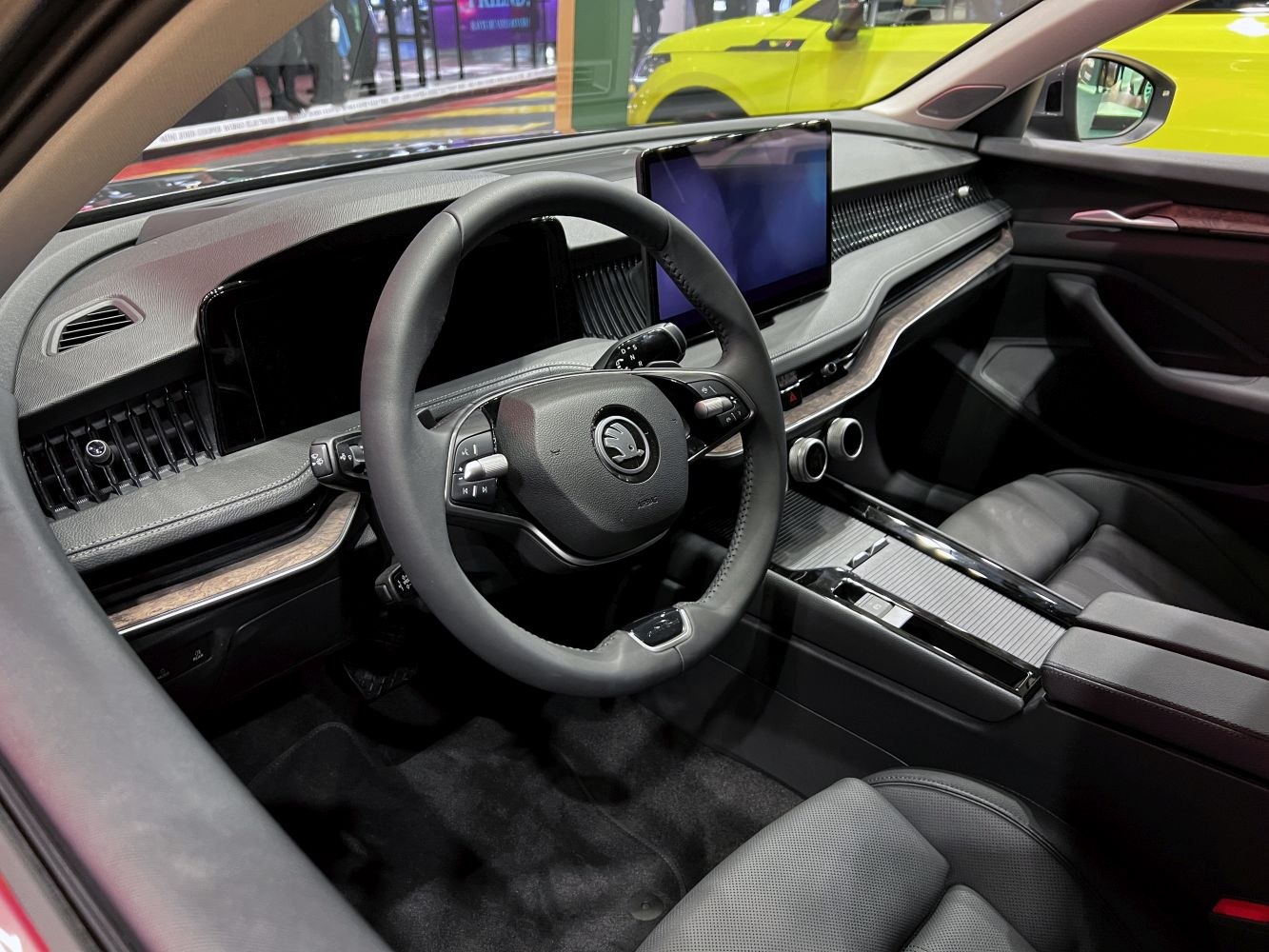 Modern car interior with digital dashboard and large touchscreen.