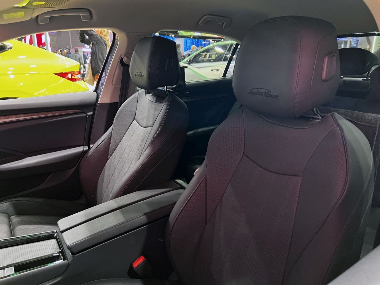 Leather front seats with embossed headrests and central armrest