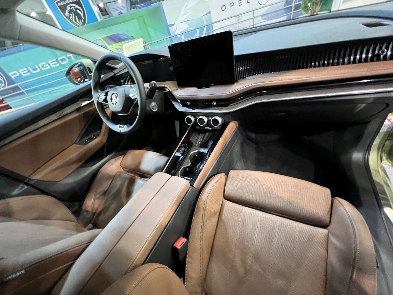Modern dashboard with digital displays and premium brown leather seats