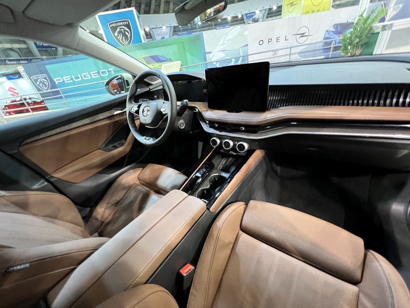 Brown leather seats and digital touchscreen in modern car interior