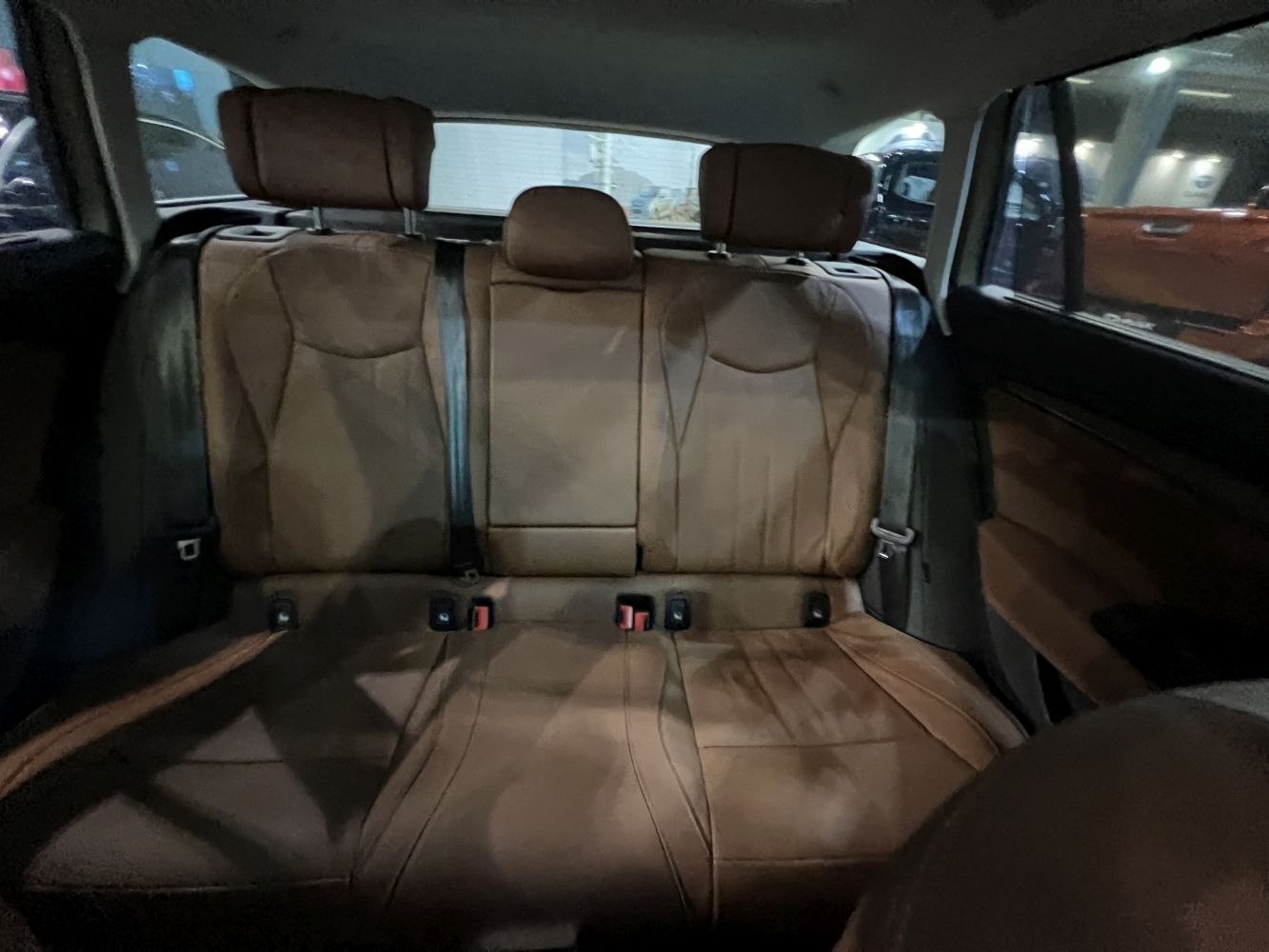 Brown leather rear seats with headrests and seatbelts