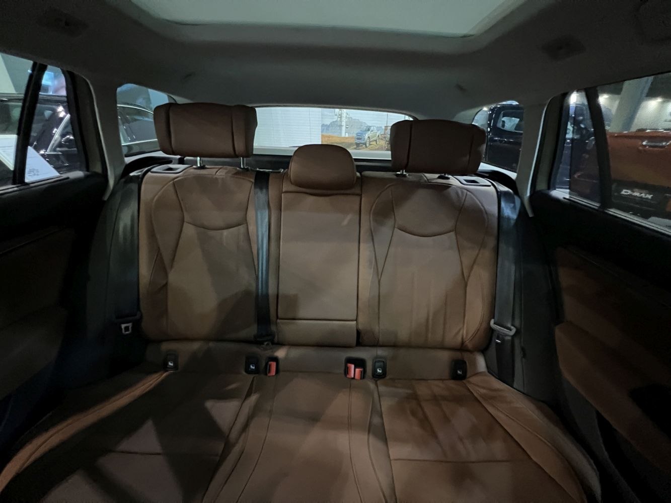 Brown leather rear seats with headrests and safety belts