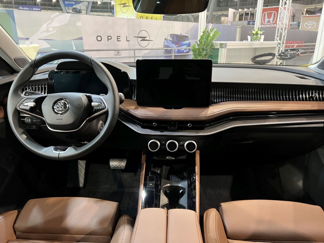 Modern car interior with digital displays and brown leather upholstery
