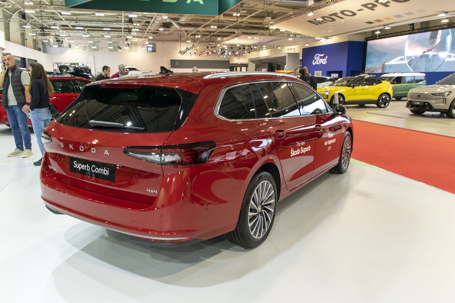 Red station wagon rear view with 4x4 badge and tinted windows indoors