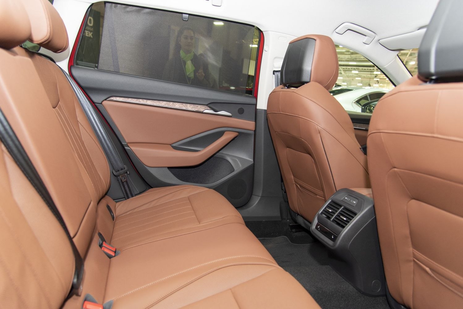 Rear seat interior with brown leather upholstery and rear air vents