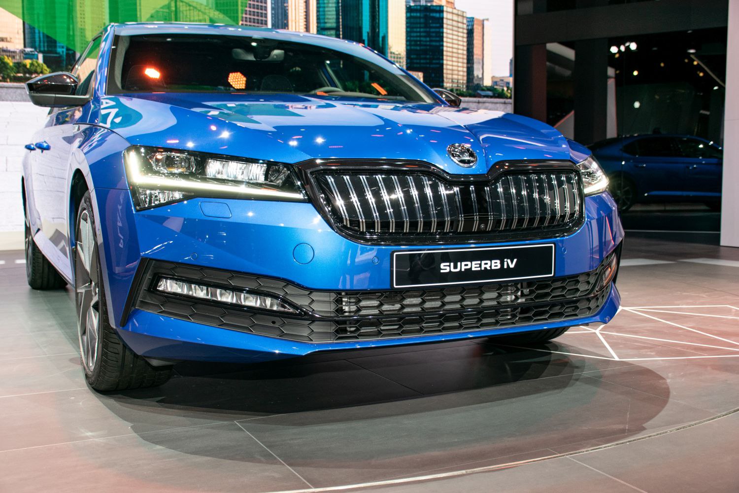 Close-up of front grille and LED headlights with hexagonal grille pattern