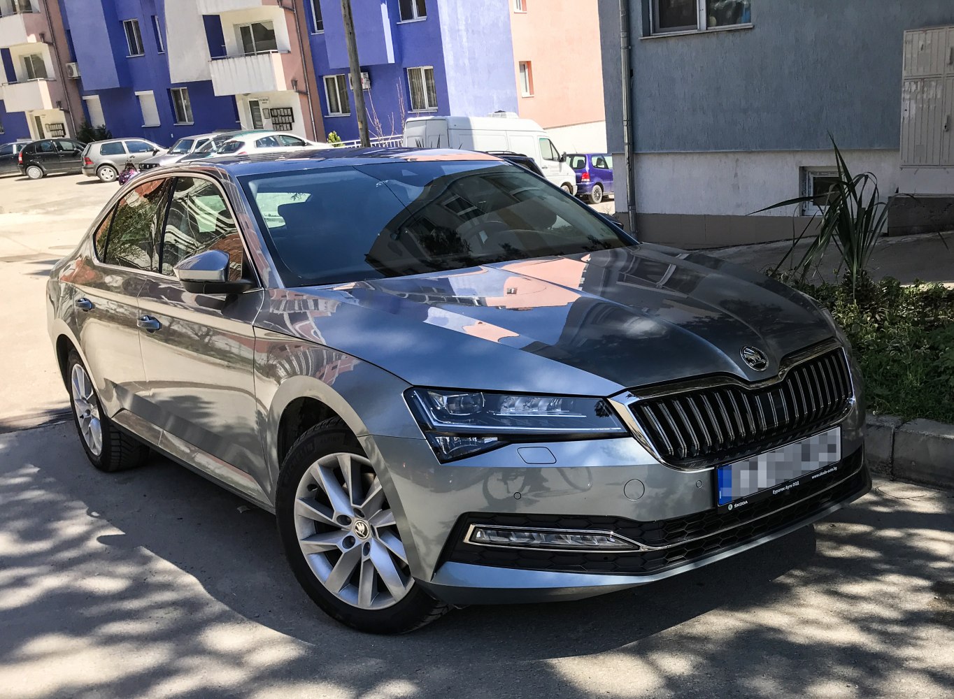 LED headlights and chrome vertical grille on a modern sedan front.