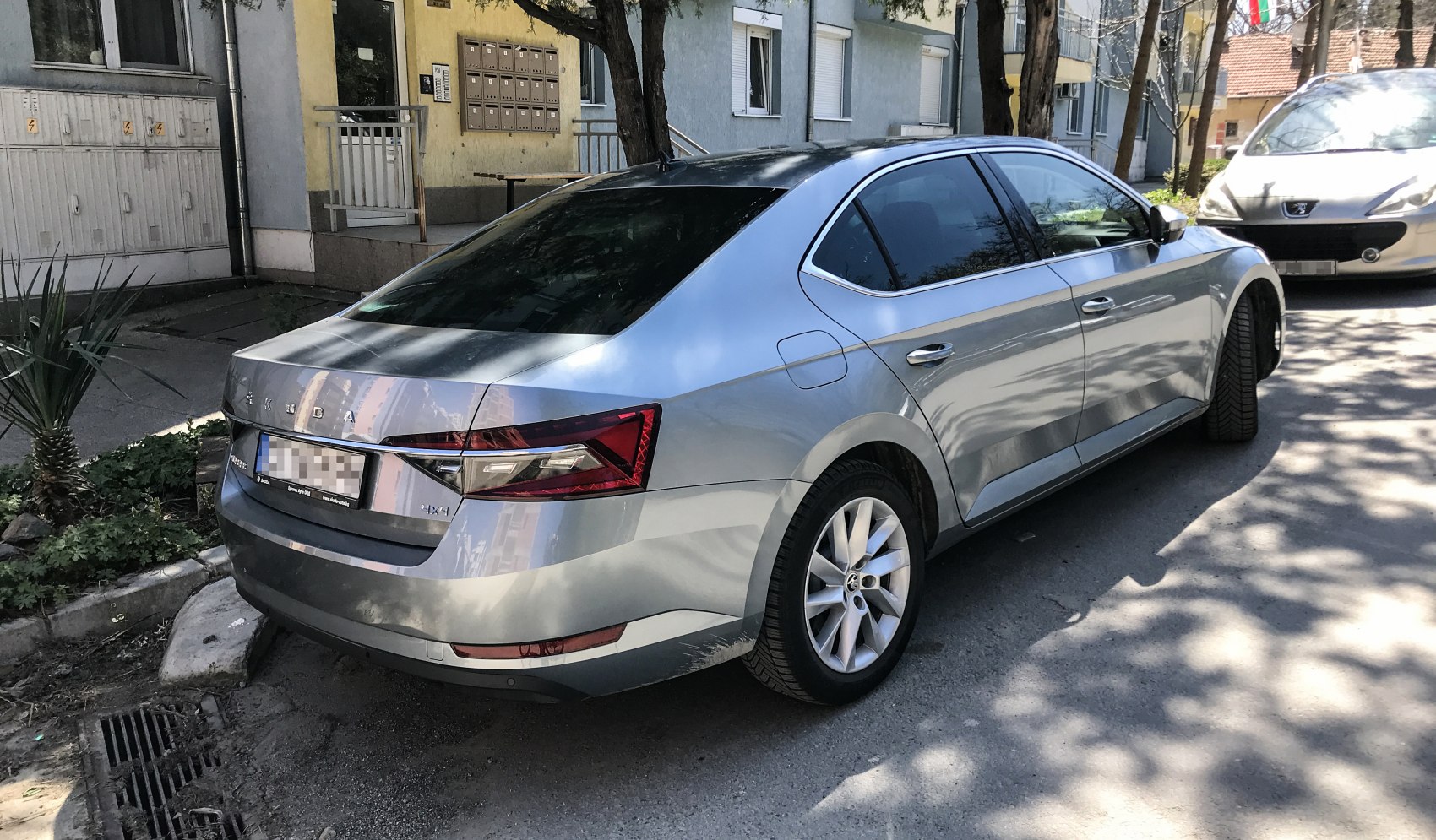Rear and side profile of midsize sedan with sharp LED taillights and alloy wheels