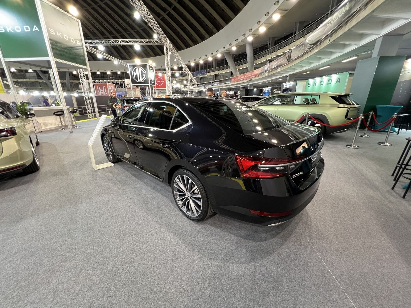 Rear and side view of a sleek black sedan with alloy wheels and modern taillights