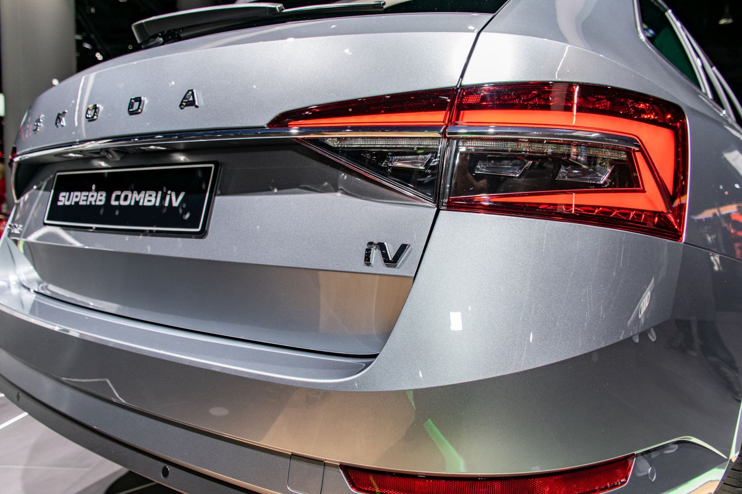Close-up of rear tail light and badge with modern lighting design.