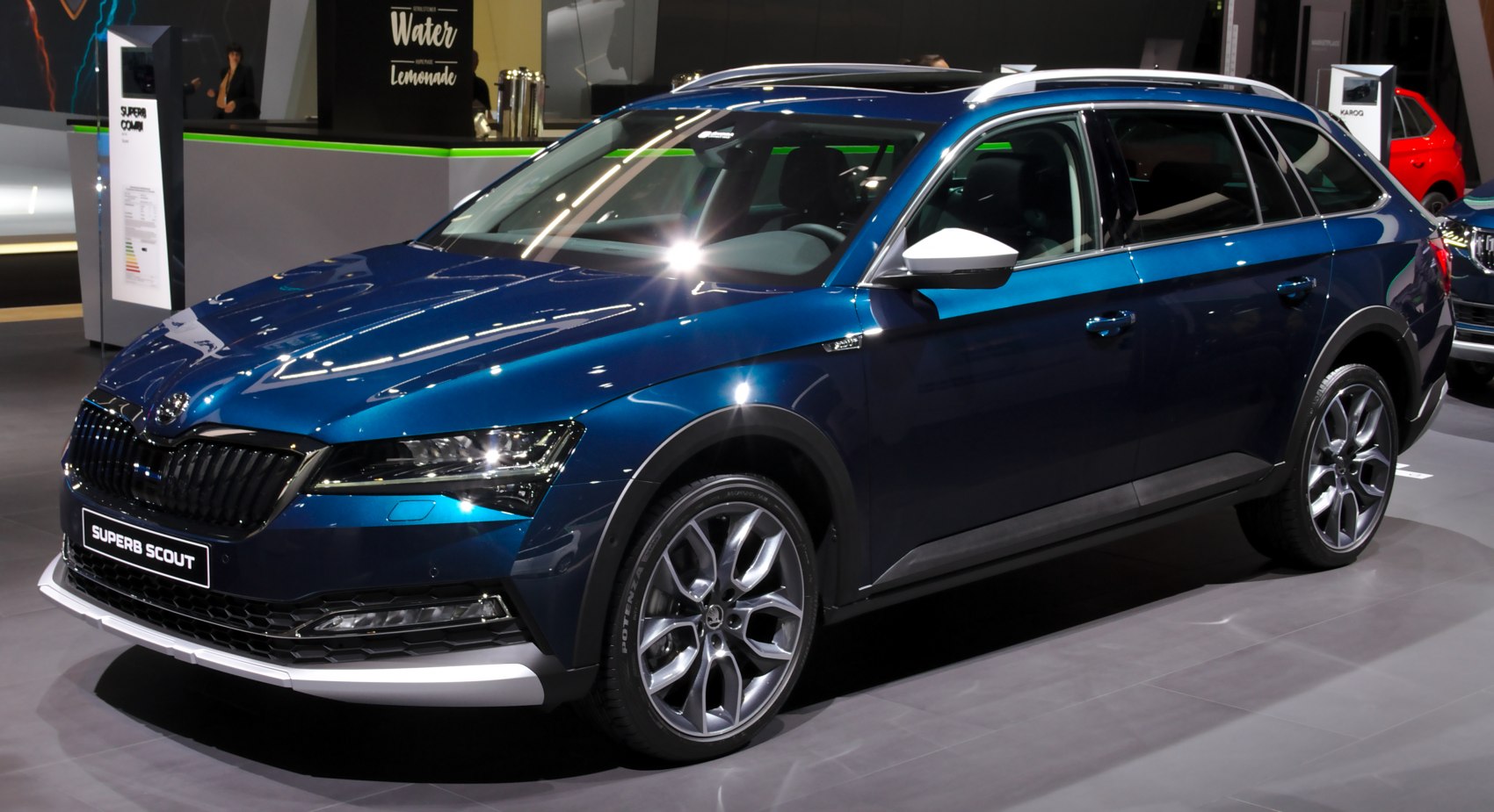 Glossy blue off-road wagon with large alloy wheels and roof rails