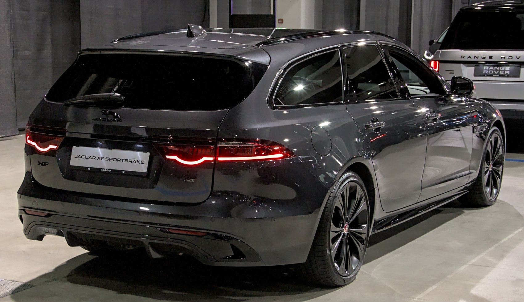Rear and side view of sleek station wagon with distinctive LED taillights and black alloy wheels