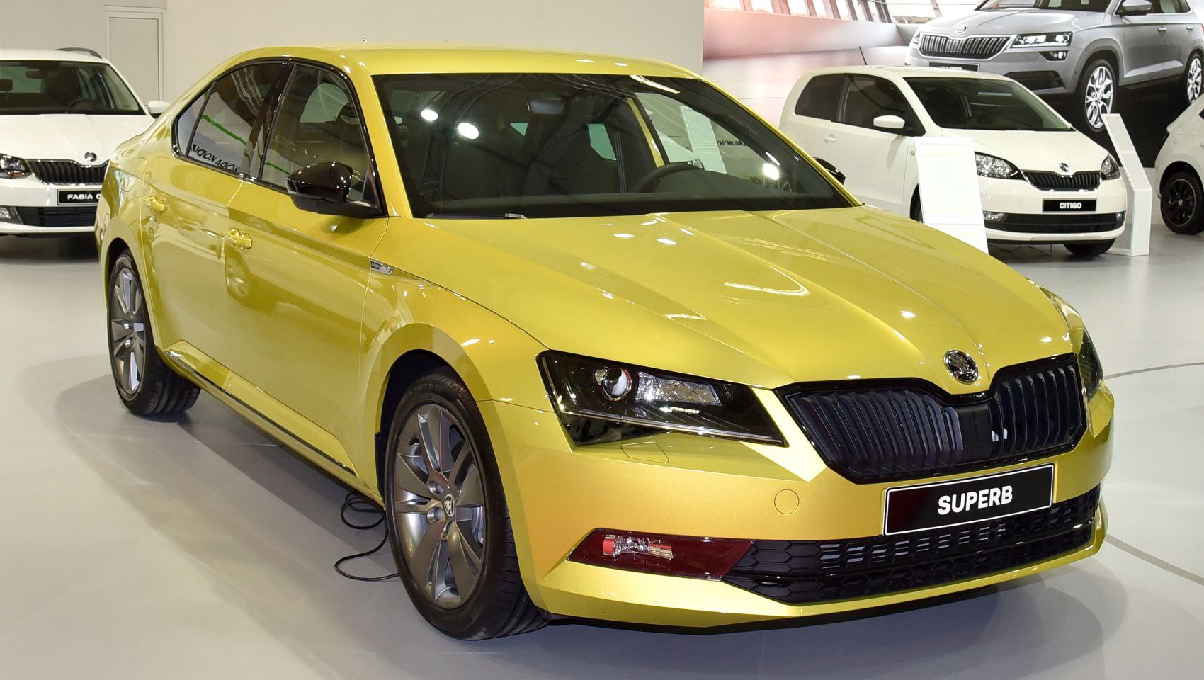 Yellow sedan with black grille and sleek headlights