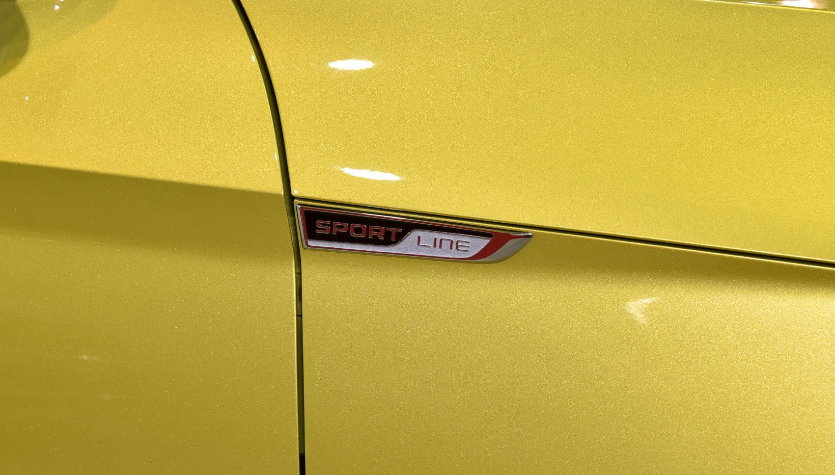 Close-up of SportLine badge on yellow car body panel