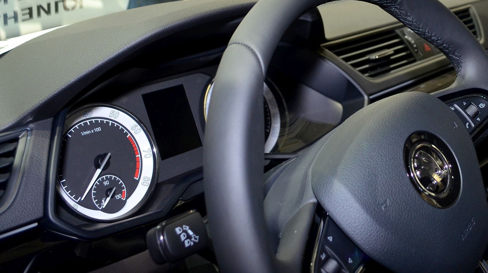 Close-up of instrument cluster and steering wheel controls