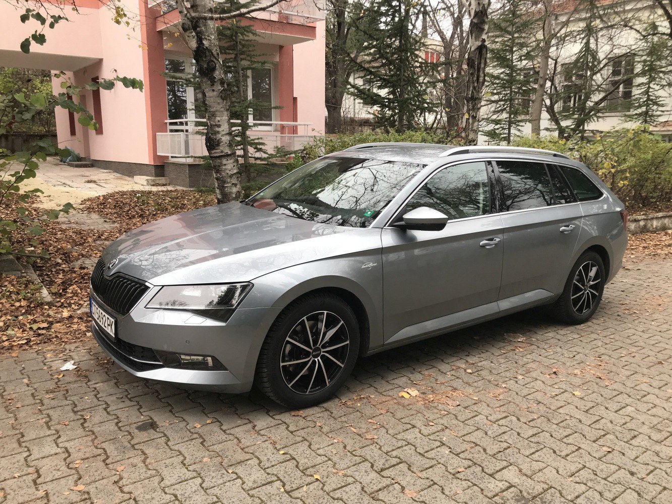 Silver station wagon front-side view with alloy wheels and roof rails
