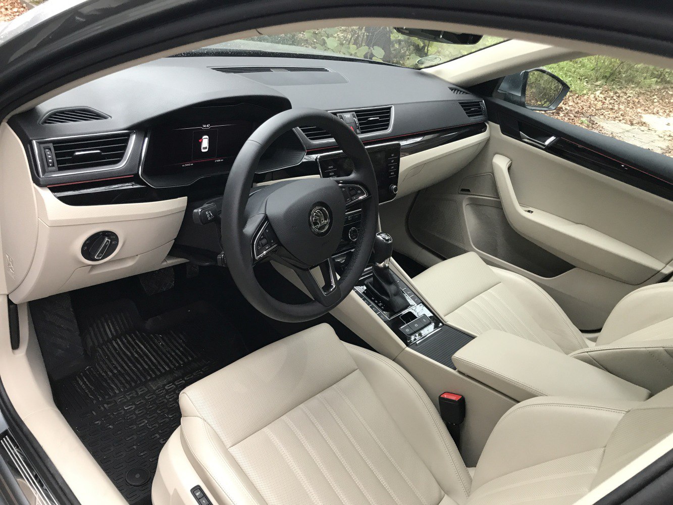 Beige leather seats and a modern dashboard with digital display