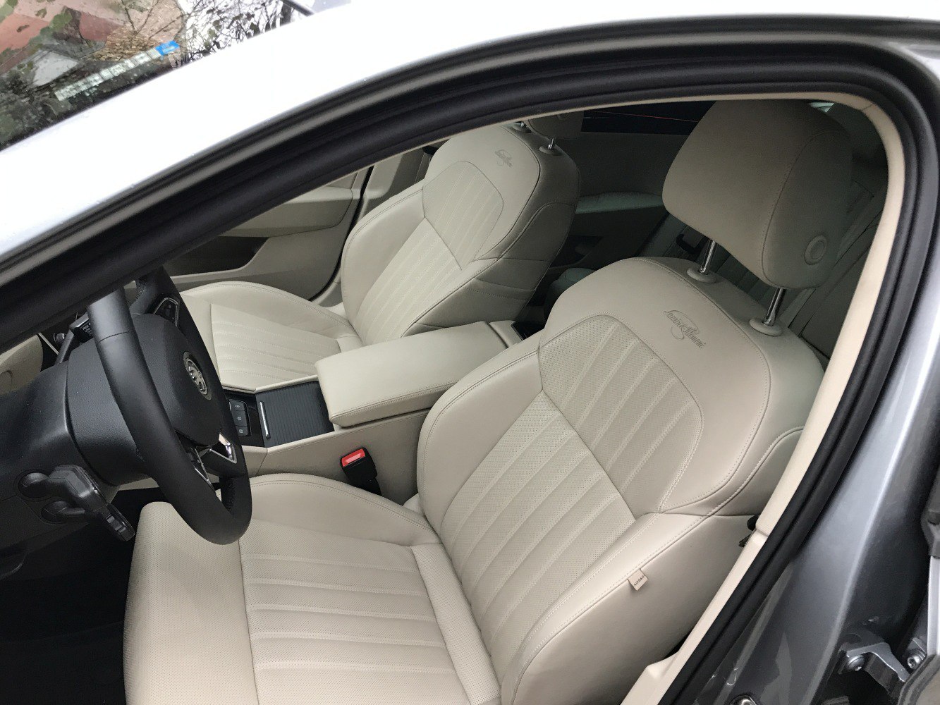 Beige leather front seats with detailed stitching and headrests