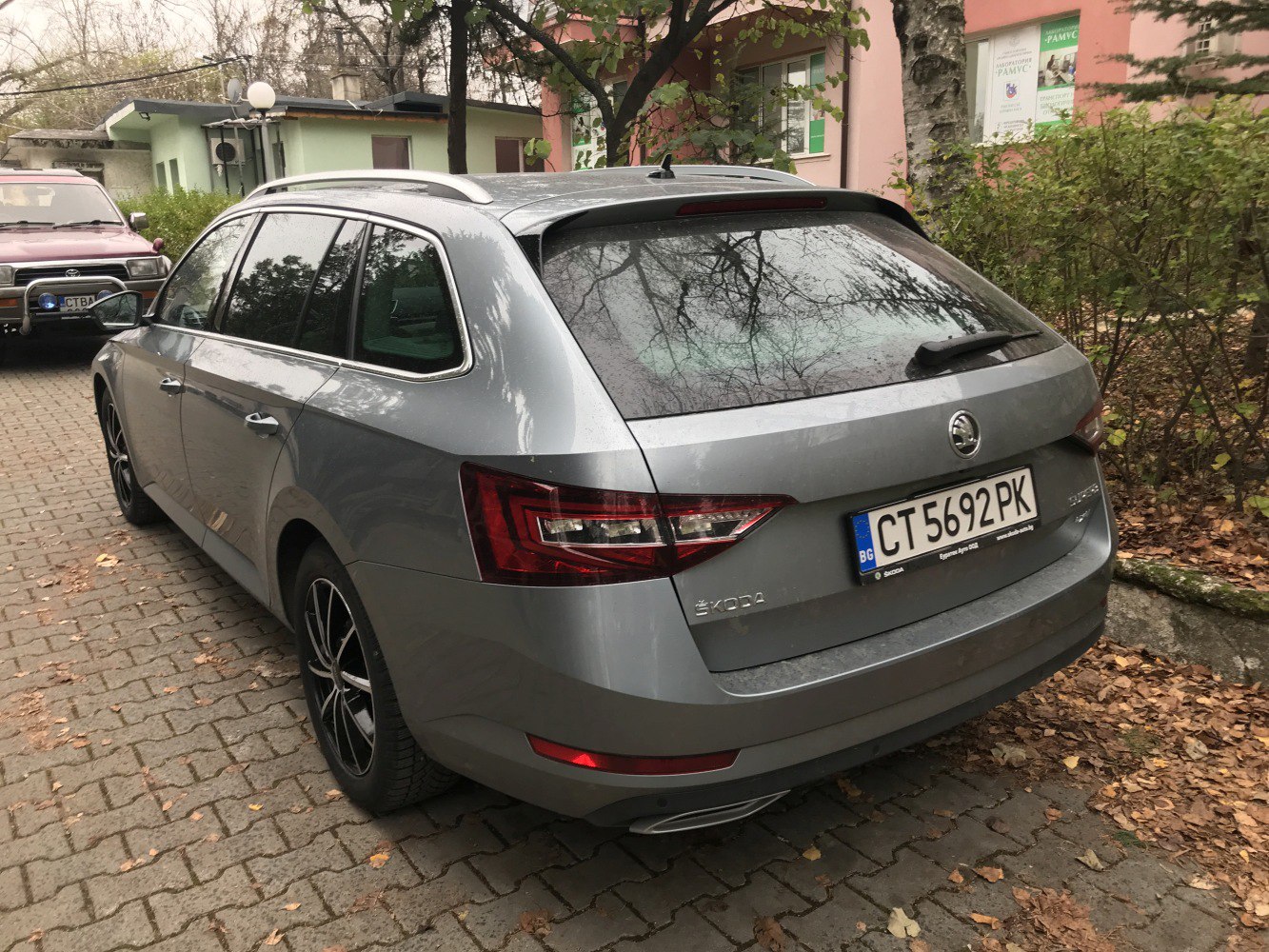 Silver station wagon rear view with roof rails and sharp taillights