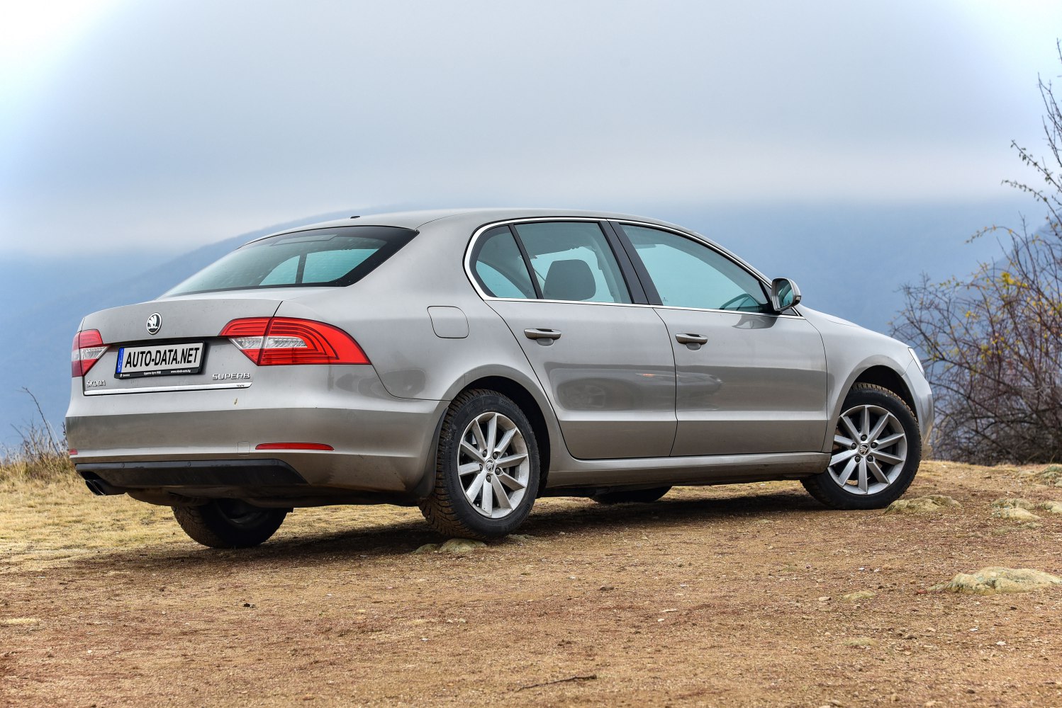 Sedan rear and side profile with distinct tail lights and alloy wheels