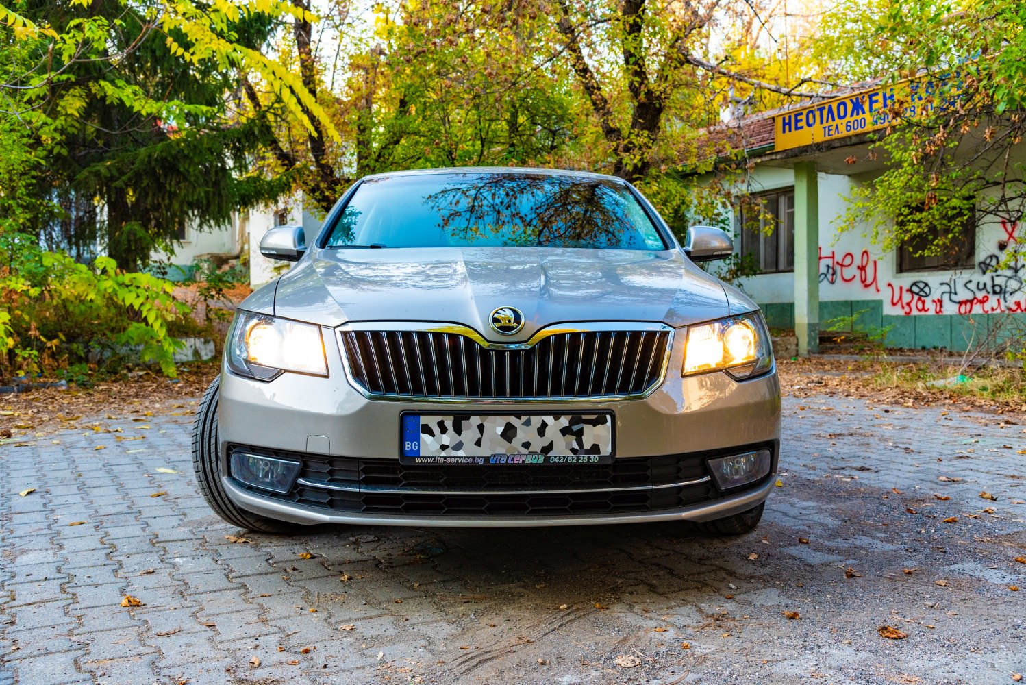 Front view with illuminated headlights and prominent grille