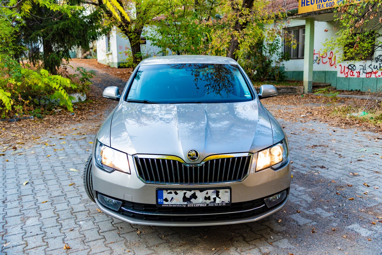 Front view with illuminated headlights and prominent grille