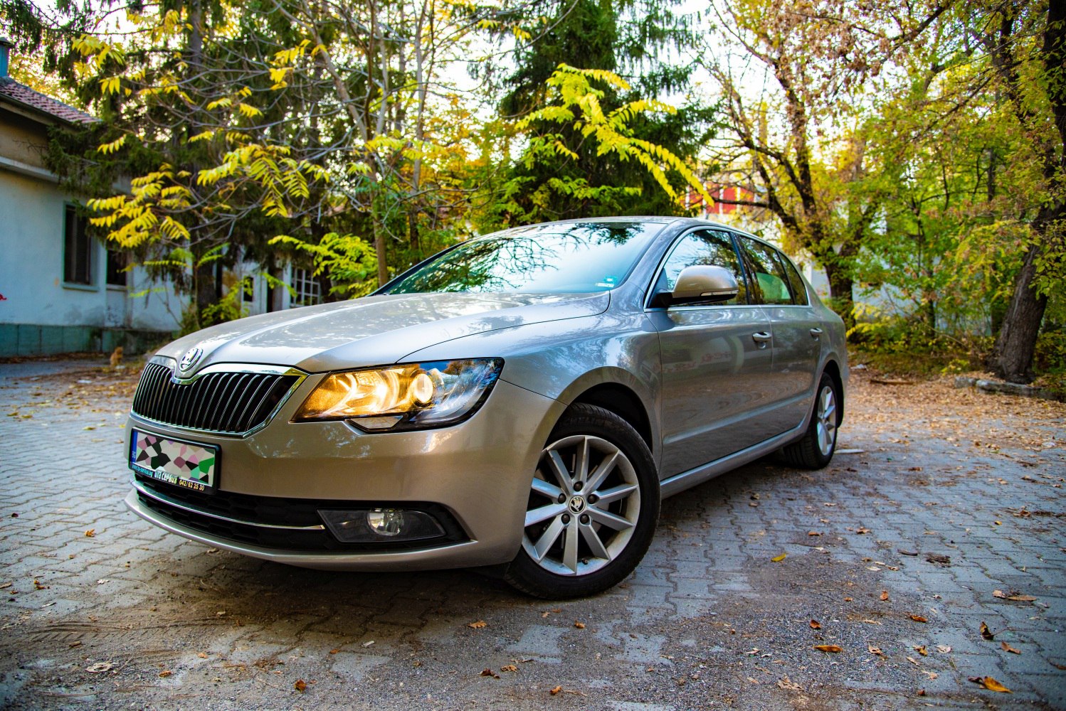 Front grille and illuminated headlights in a sedan.
