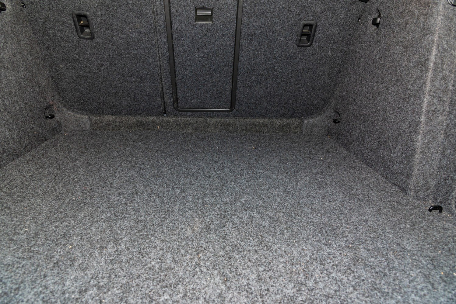 Spacious carpeted trunk interior with fold-down rear seat pass-through