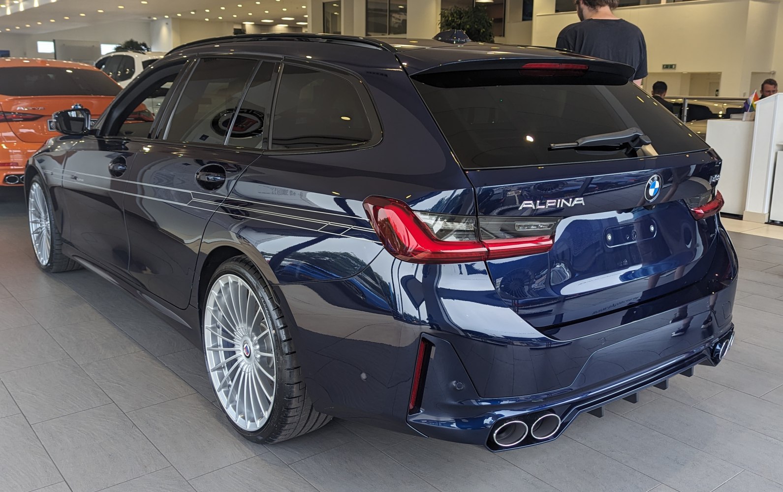 Rear view showcasing quad exhausts and Alpina multi-spoke wheels