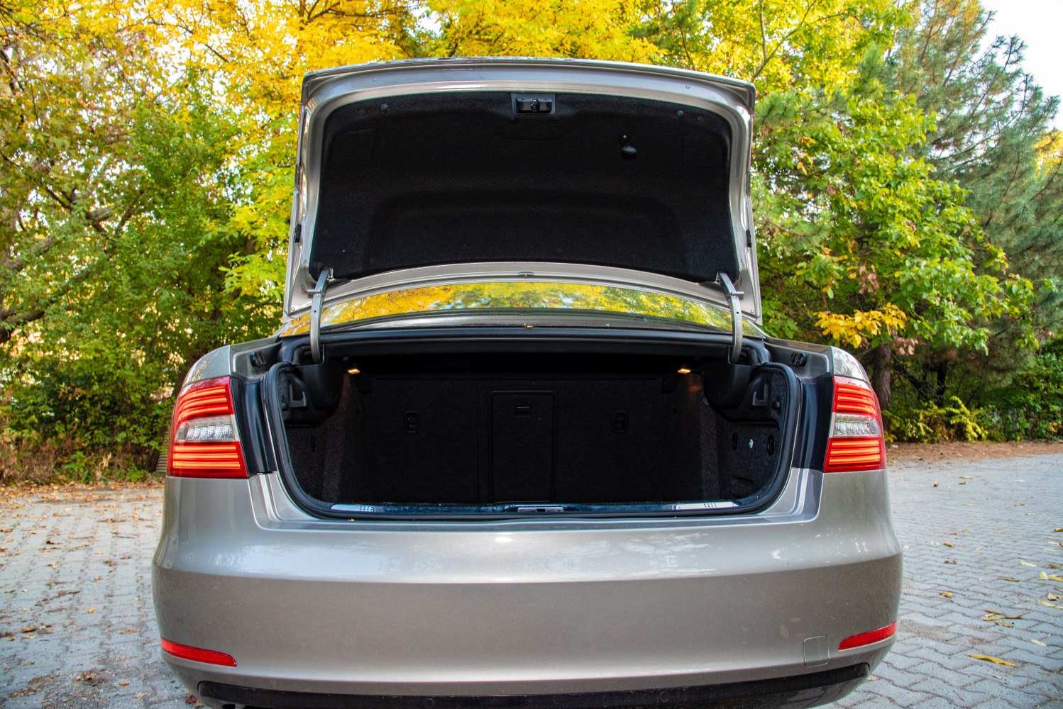 Open sedan trunk showcasing spacious cargo area and rear taillights