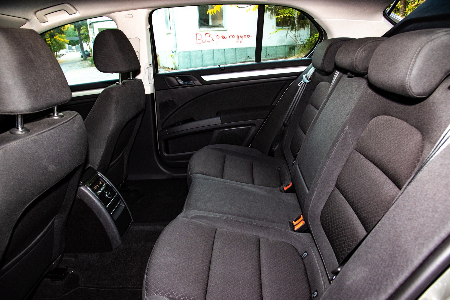 Spacious rear car seats with headrests and door panel