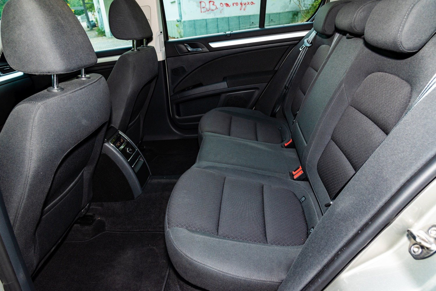 Rear interior seats with dark fabric upholstery and seatbelts.