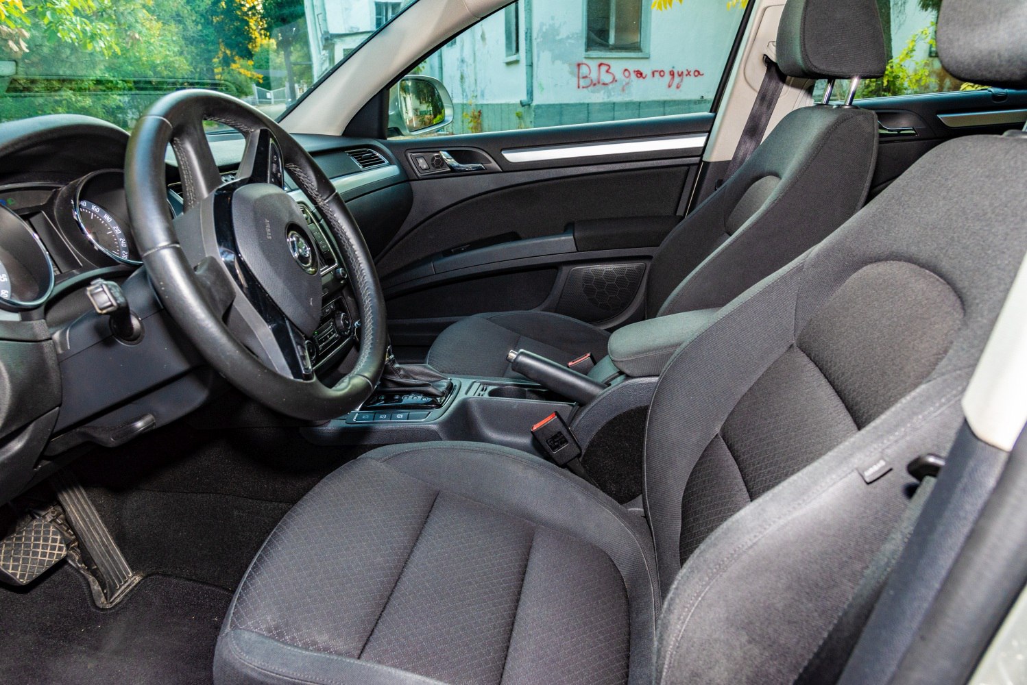 Front seats, steering wheel, and dashboard interior view