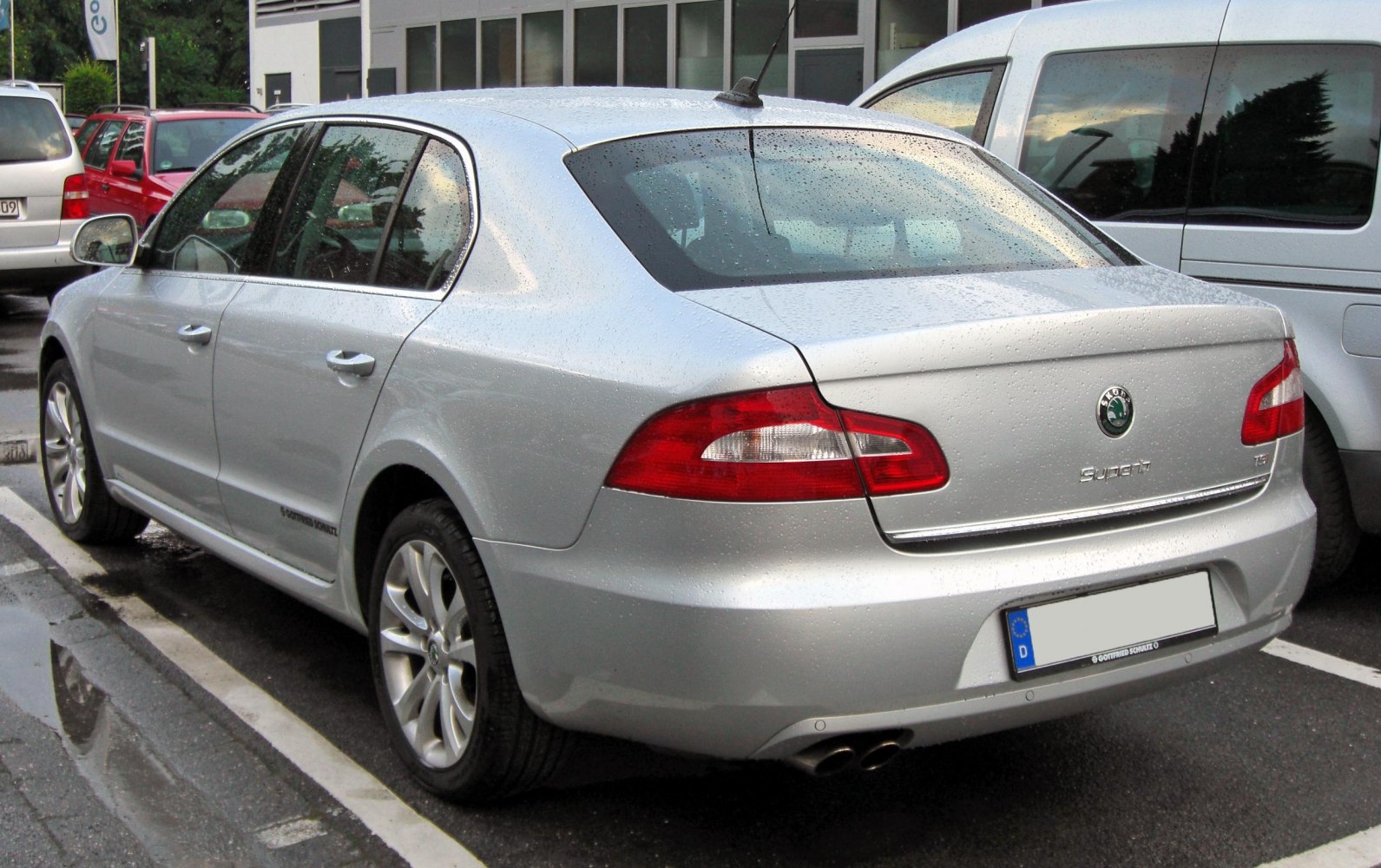 Silver mid-size sedan rear view with dual exhausts and taillight design