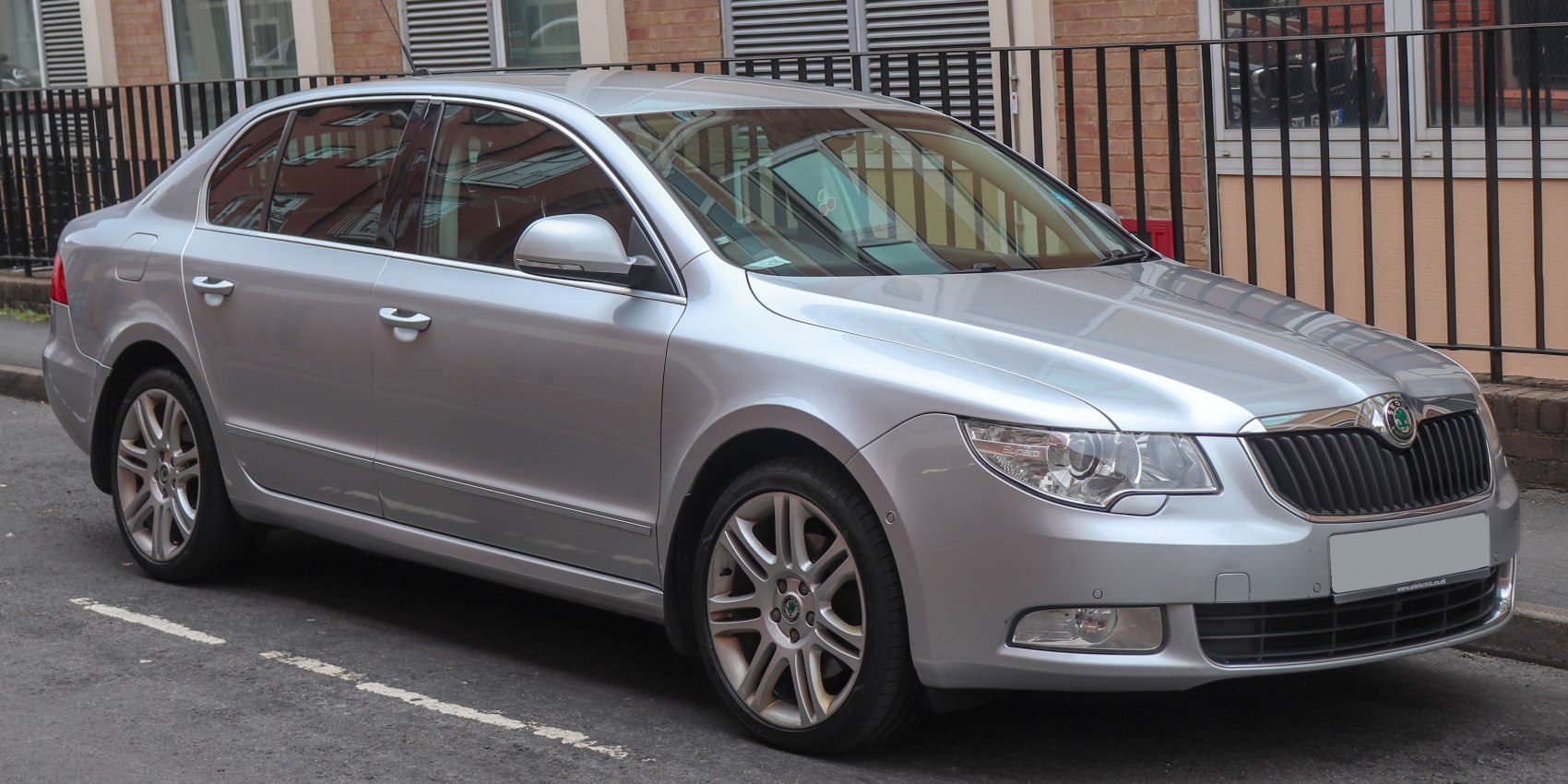 Silver sedan front side with alloy wheels and headlights
