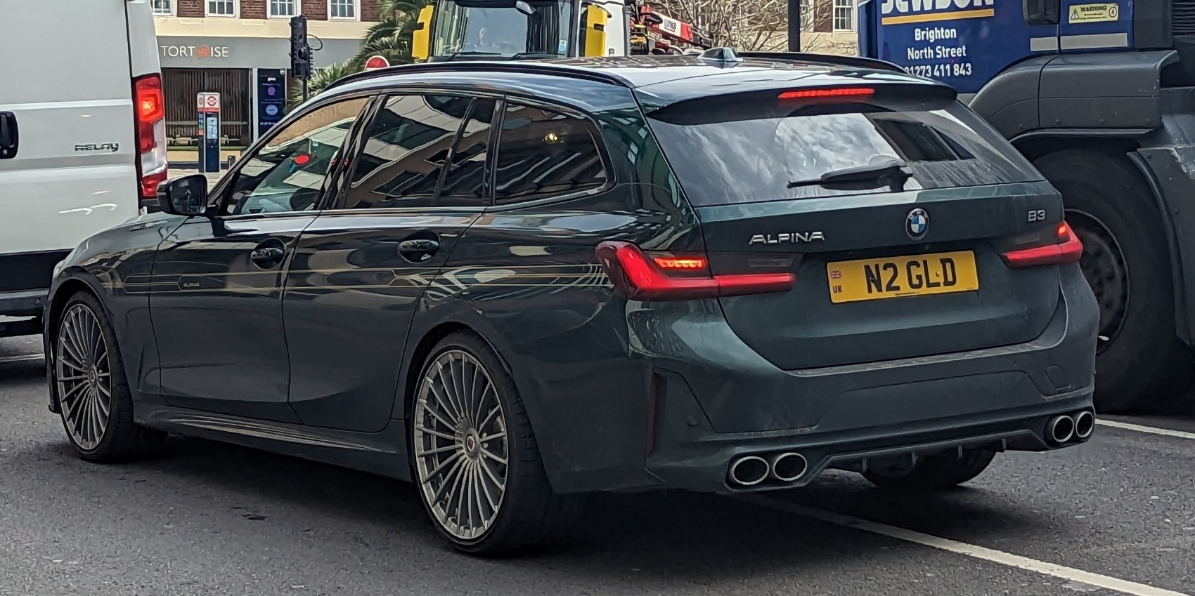 Rear view of sporty wagon with quad exhaust and multi-spoke wheels