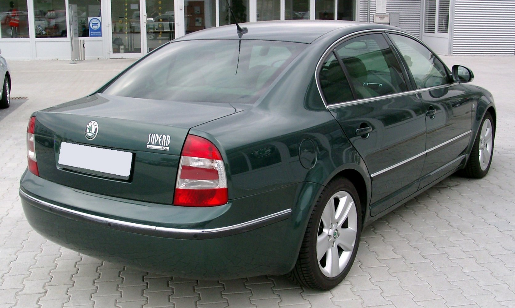 Rear view of sedan with distinctive taillights and chrome trim