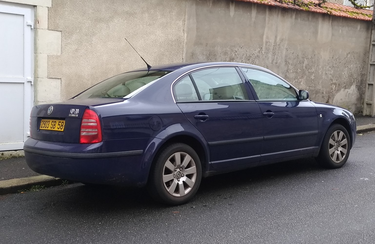 Rear side view of a mid-size sedan with alloy wheels and classic rear lights