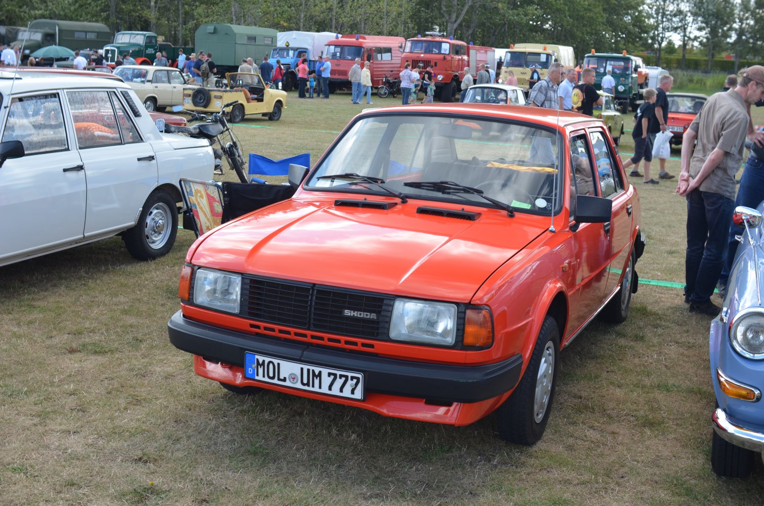 Orange 1980s boxy sedan with rectangular headlights and black trim