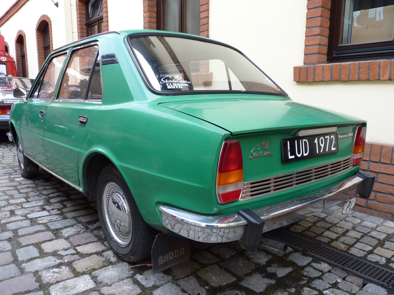 Classic vintage sedan rear with distinctive taillights and chrome bumper.