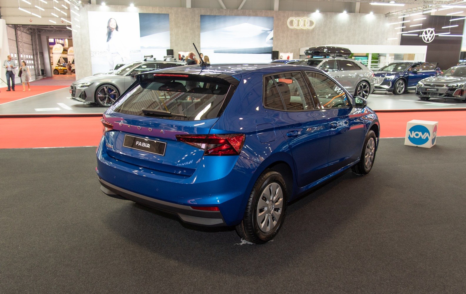 Rear view of blue hatchback with sharp angular tail lights indoors